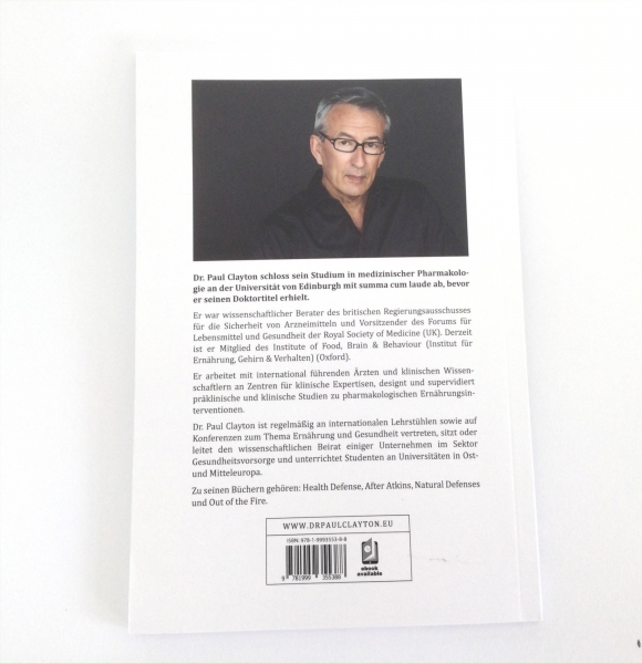 Zu sehen ist die Rückseite eines Buches von Dr. Paul Clayton. Im oberen Teil sieht man ein Foto von ihm vor schwarzem Hintergrund. Er ist circa 60 Jahre alt, hat kurze graue Haare, trägt eine Brille, ein schwarzes Hemd und schaut freundlich in die Kamera.